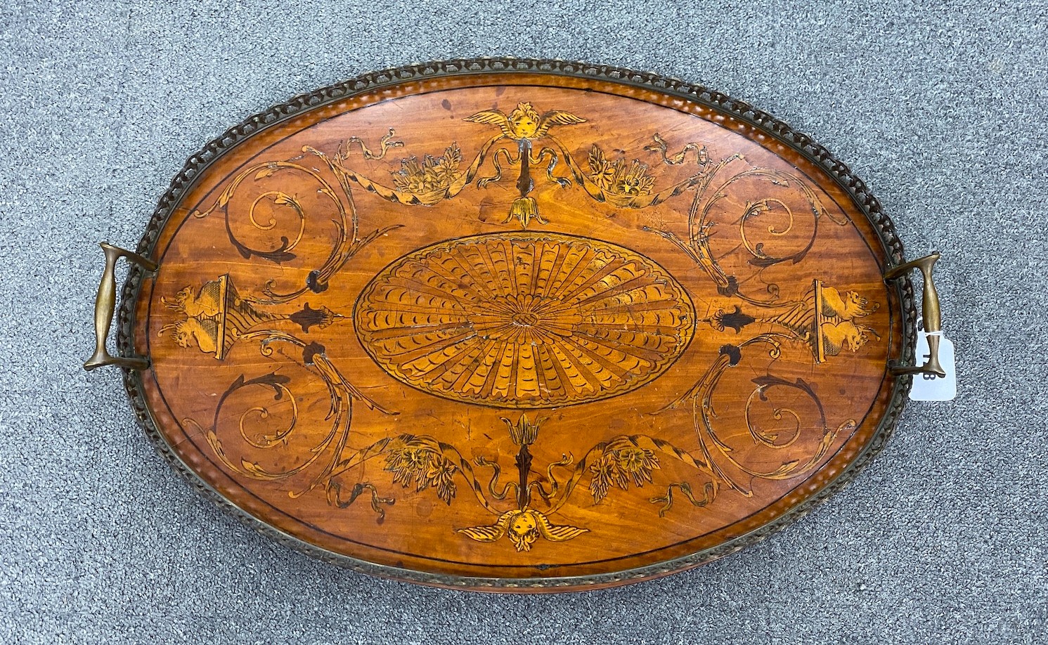 An Edwardian oval marquetry inlaid mahogany galleried tea tray, width 58cm, depth 40cm